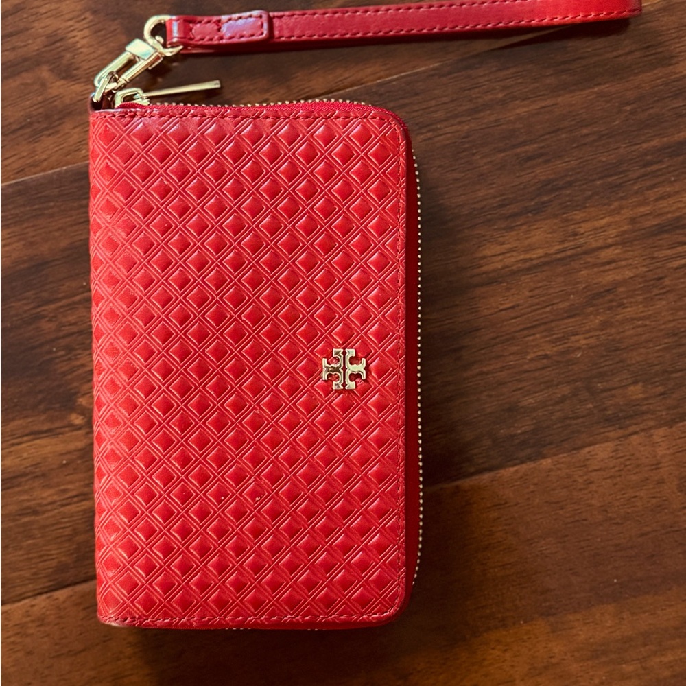 Used Tory Burch red leather wallet. Fits an iPhone pro max.
